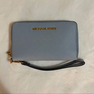 michael kors wristlet in a dusty/baby blue color!